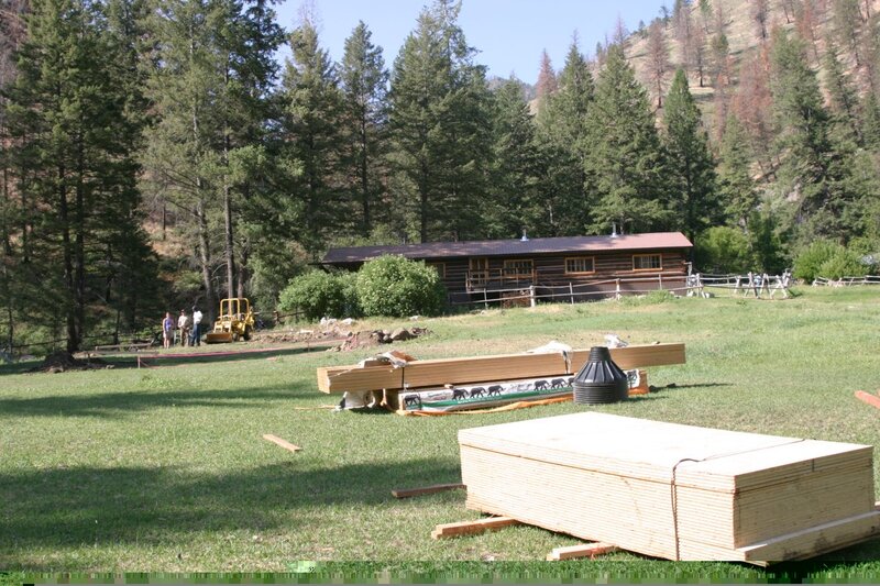 Foundation beams, plywood & forms for the concrete pier footings are delivered.