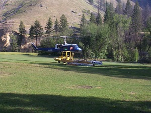 Helicopter landing the backhoe at Taylor.