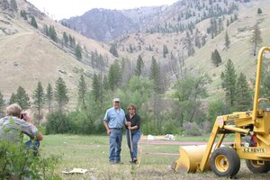 Jim & Janet Pope break ground for the DeVlieg Living Learning Center log cabin at Taylor Ranch