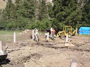 Starting to pour concrete in the foundation piers.