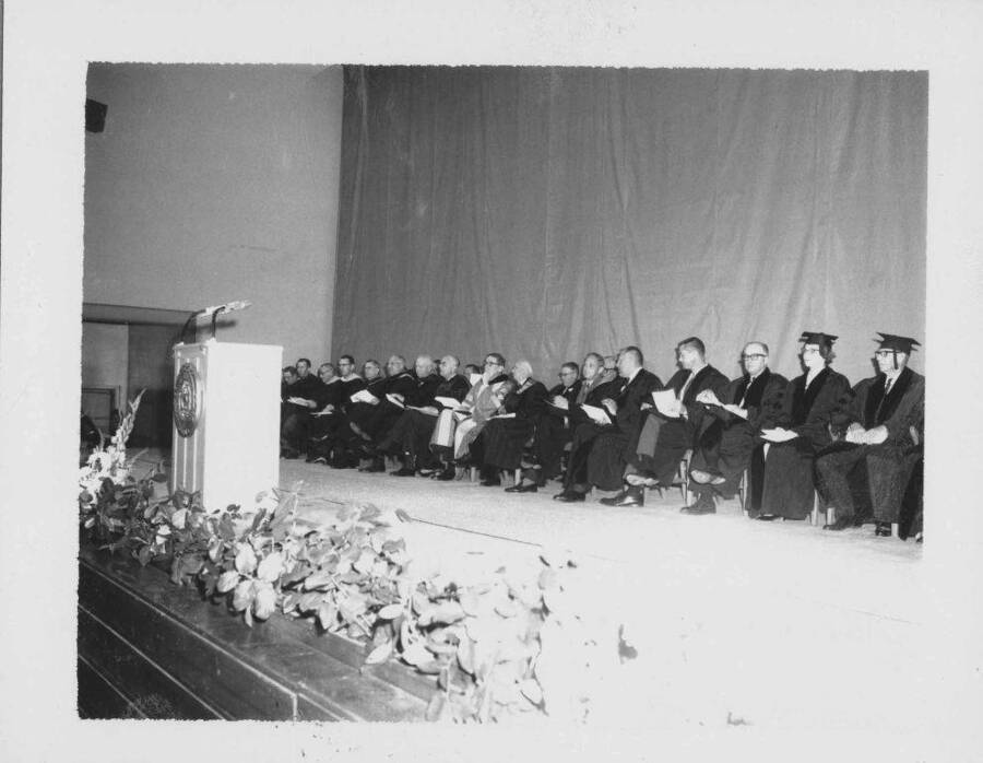 Platform group on stage during commencement.