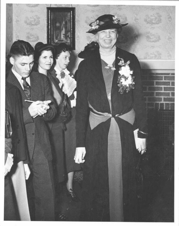 Anna Eleanor Roosevelt at a press conference in U of I President Dale's home. Caption reads: 'Left to right: Victor Skiles, ?, ?, Mrs. F. D. Roosevelt.'