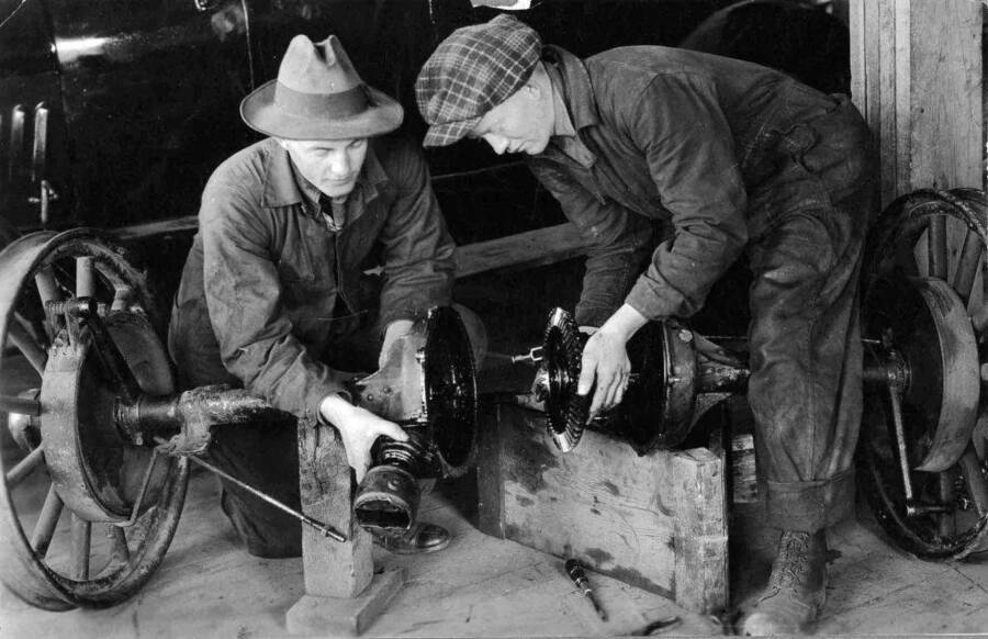 Unidentified students working on an axle in the shop.