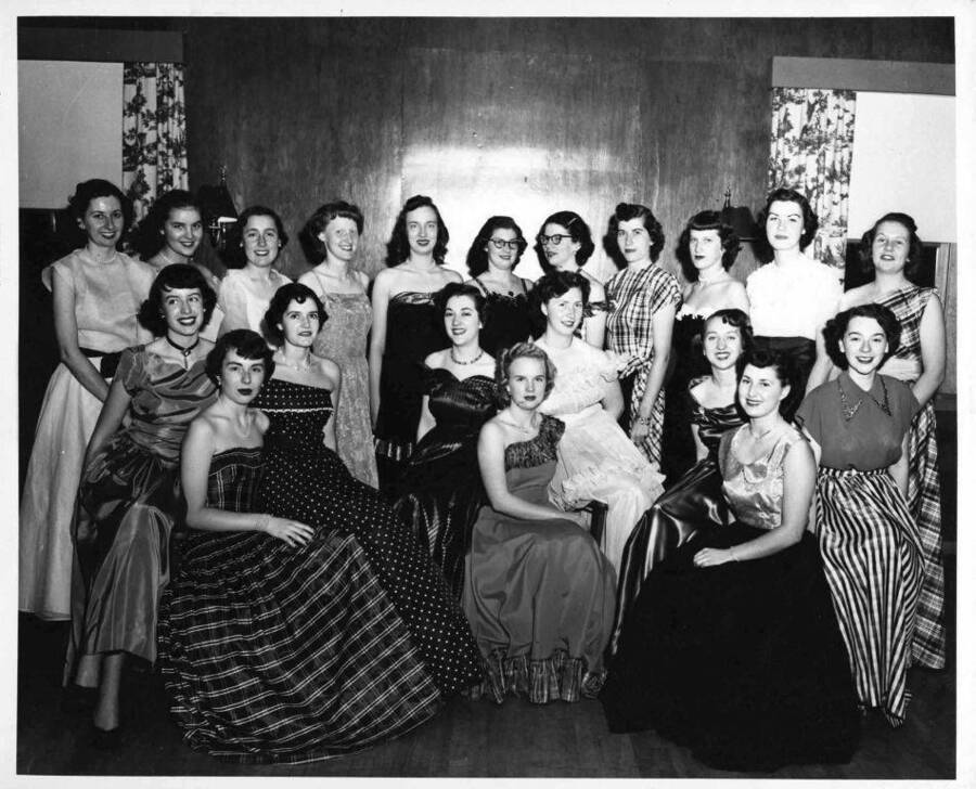 These twenty University of Idaho coeds are shown after recent initiation ceremonies of Sigma Alpha Iota, women's music honorary. Left to right, seated, are Naomi Nokes, Jody Raber, Jo Peters, Pat Rambo, Ester Simons, Jean Jacobs, Joan Coble, Joyce Walser, and Bernice Bauer.  Standing, left to right, are Rita Reynolds, Nancy Shelton, Elisabeth Wilcox, Joan Parks, Margie Moline, Delores Knight, Ann Pickett, Barbara Clauser, Ruth Beiber, Beverly Schupfer, and Margaret Mehl.