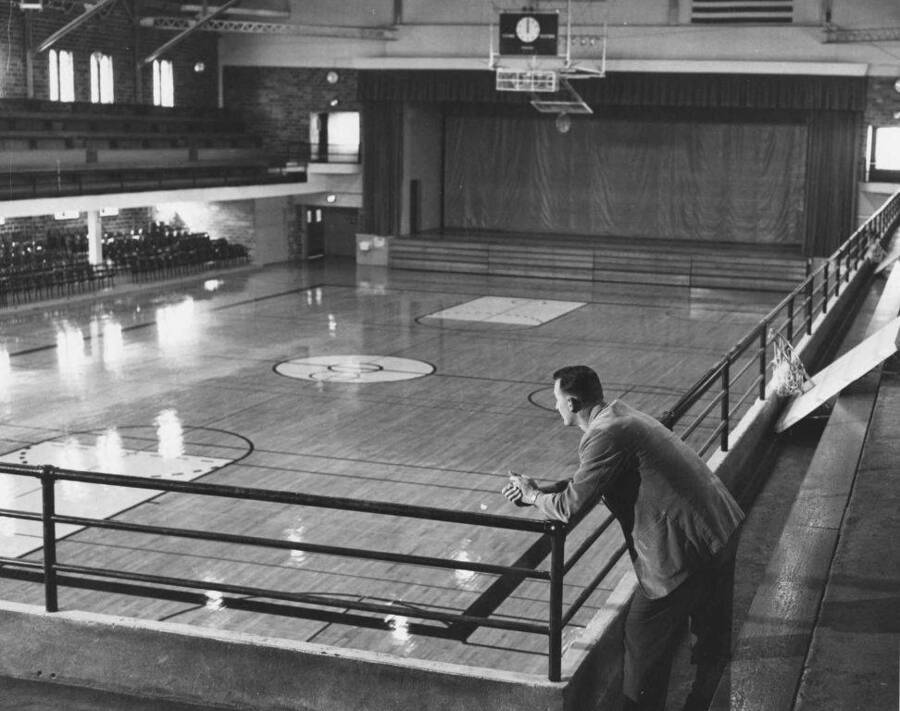 Coach Joe Cipriano leans against a railing inside Memorial Gymnasium.