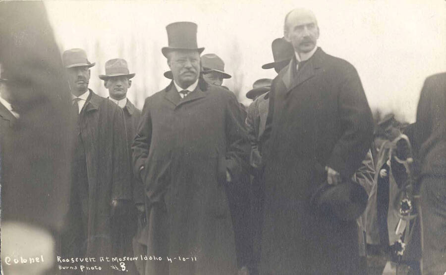 President Roosevelt standing with a group of men. To his left is University of Idaho president James MacLean. Writing on image reads: 'Colonel Roosevelt at Moscow Idaho 4-10-11 Burns photo #8.'