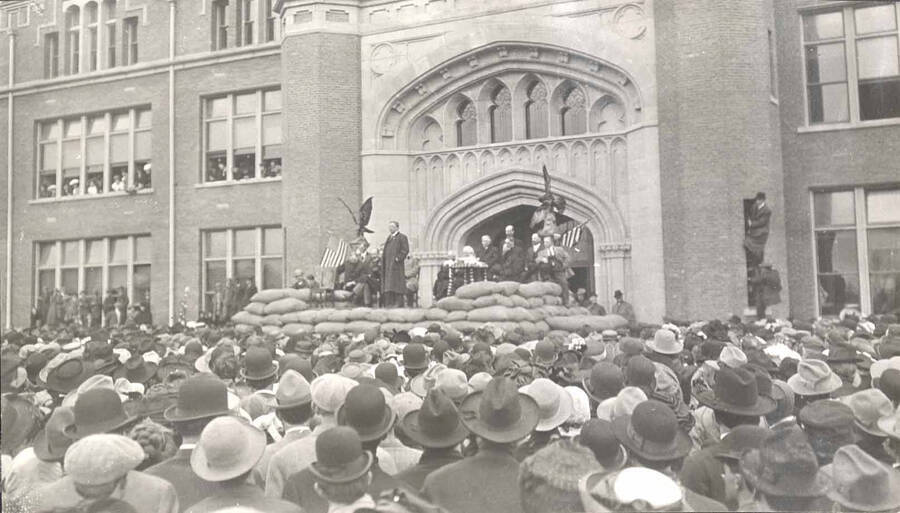 Theodore Roosevelt stands on a platform in front of University of Idaho Administration Building.