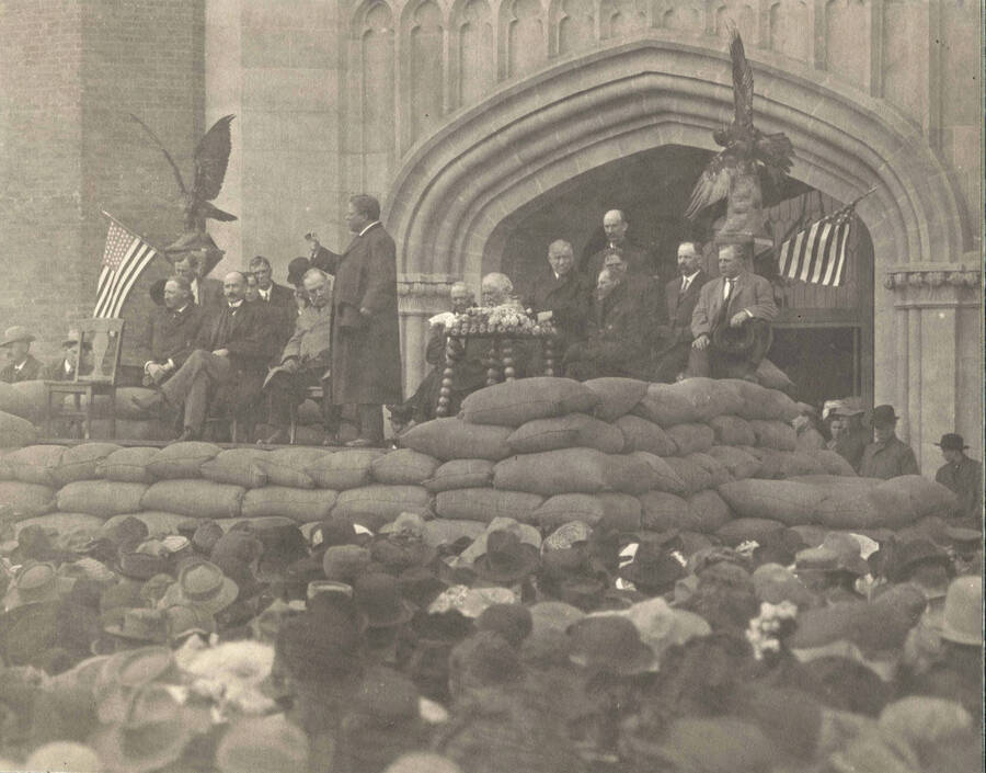 Theodore Roosevelt speaking from platform in front of University of Idaho Administration Building.
