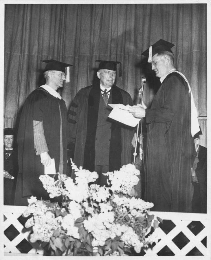 An honorary Doctor of Laws degree was awarded by the University of Idaho at commencement exercises to Stanly A. Easton (center, Kellogg), president of the Bunker Hill and Sullivan Mining and Concentrating company. He is shown with Dean A. W. Fahrenwald of the school of mines at the university and President J. E. Buchanan.