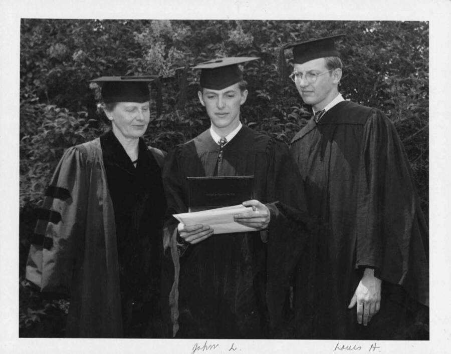Mrs. Maude Cosho Houston of Boise, a member of the board of regents of the University of Idaho, who saw two sons receive their degrees in the 1948 graduating class. Louis (left) received the bachelors of arts degree, while John received a bachelor of science. The Cosho boys missed by one year having their mother's signature on their diploma. Last year, as secretary of the board of regents, Mrs. Houston signed all of the university diplomas.