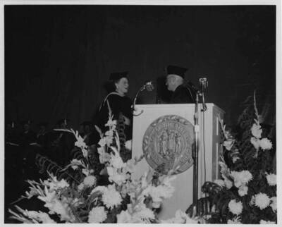 Louise Carter, Dean of Women retires. President D. R. Theophilus reads the citation of merit.