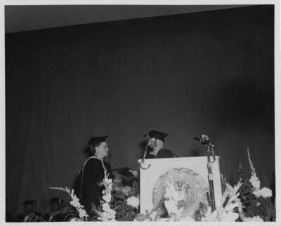 Louise Carter, Dean of Women retires. President D. R. Theophilus reads the citation of merit.