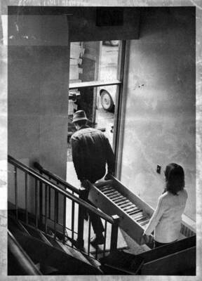 Books being carried from old building to trucks for transporting to new building.