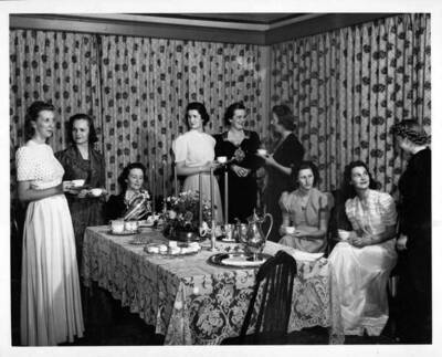 Students participating in a formal tea for Home Economics.