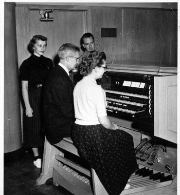 Students majoring in the organ phase of music at the University of Idaho received a few pointers from a master of the instrument - Carl Weinrich, touring concert artist. Seated with him at the organ is Margaret Johnson, Blackfoot.  Observing the instructor is Shirley Danelson of Genesee and James Horn, Cicero, Illinois.