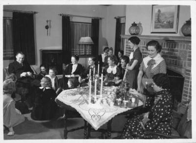 People gather in the living room of Forney Hall.