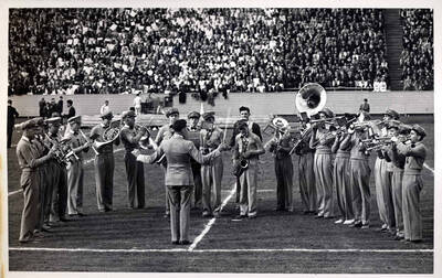 Marching band on field being conducted.