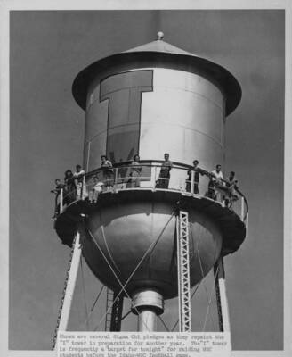 Shown are several Sigma Chi pledges as they repaint the "I" tower in preparation for another year.  The "I" tower was frequently the targeted for raiding WSC students before Idaho-WSC football games.