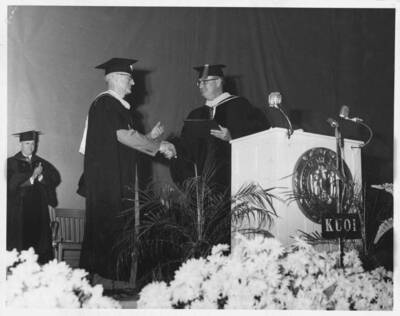 Citation Upon Award of Certificate of Merit and Appointment Emeritus 6 June 1954. For thirty-five years our campus has been home for the man who has earned the world over the very appropriate but non-professional title of Mr. Flotation. For twenty-one of those years Arthur W. Fahrenwald has been dean of our College of Mines and director of the Idaho State Bureau of Mines and Geology. New processes and new machines growing out of his research here are now in use in every mining district throughout the world. It is safe to say that 75 percent of all the ore treated by flotation goes through processes and machinery having their origin in his research at Idaho. The world over, flotation and Fahrenwald have became synonymous. many times he has been called to mining districts abroad to help on some special metallurgical problem. Through his contribution to more efficient and economical mineral recovery, millions of dollars have been added to the income of Idaho's mining industry throughout the world. "To you, Dean Fahrenwald, by authority of the Regents, it is a pleasure and an honor to present with hearty congratulations and best wishes this certificate of merit and appointment emeritus effective upon your retirement from your deanship, 1 September 1954." J. E. Buchanan, President.