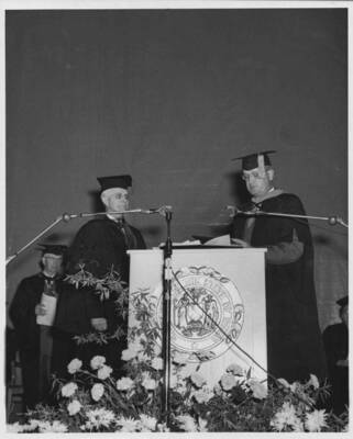 Dean Jeffers, retiring, and President Buchanan on commencement stage.