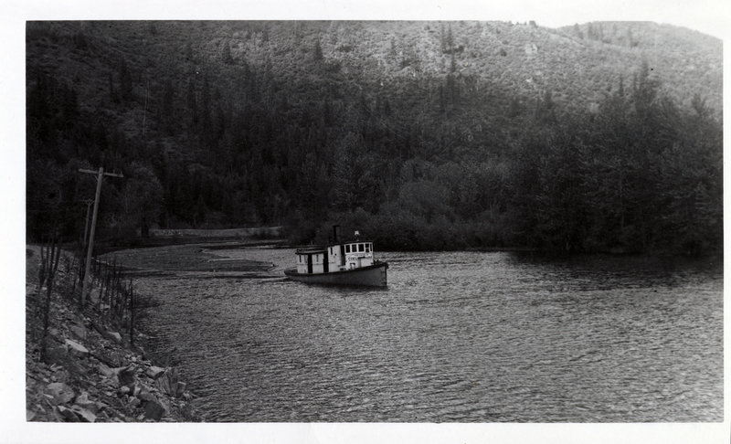 Tugboat towing logs on St. Joe River above St. Maries towards Coeur d'Alene.