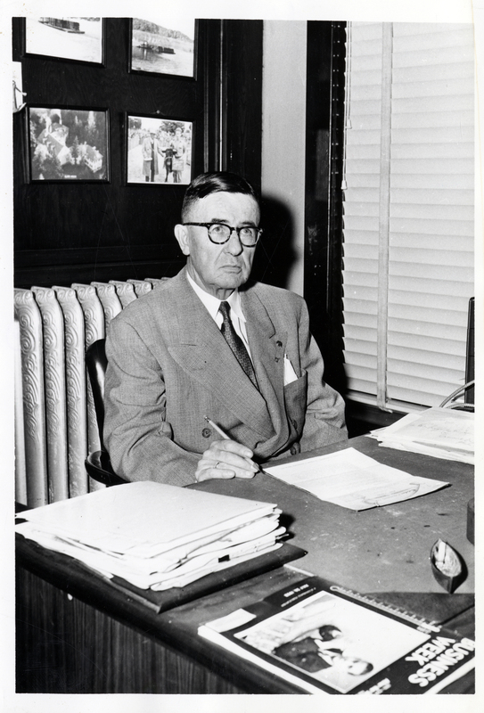 Al B. Lafferty sitting at a desk. Lafferty was the longtime owner and manager of Lafferty Transportation Company.