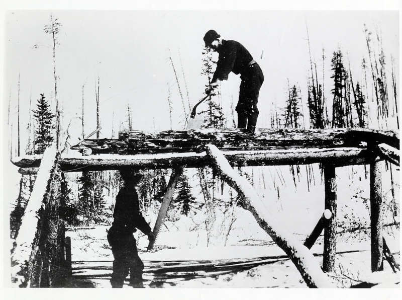 Whipsaw mill in action during wintertime.Two unknown men working together. Credit to the Idaho Historical Society
