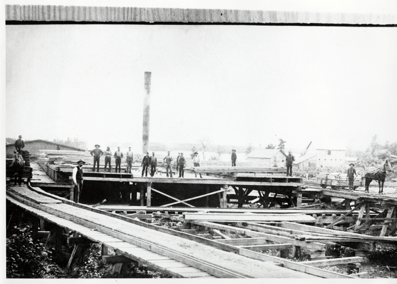 Employees standing around at the Coeur d'Alene Lumber Company sawmill.