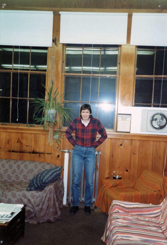 A person standing in front of a radiator in the Women's Center.