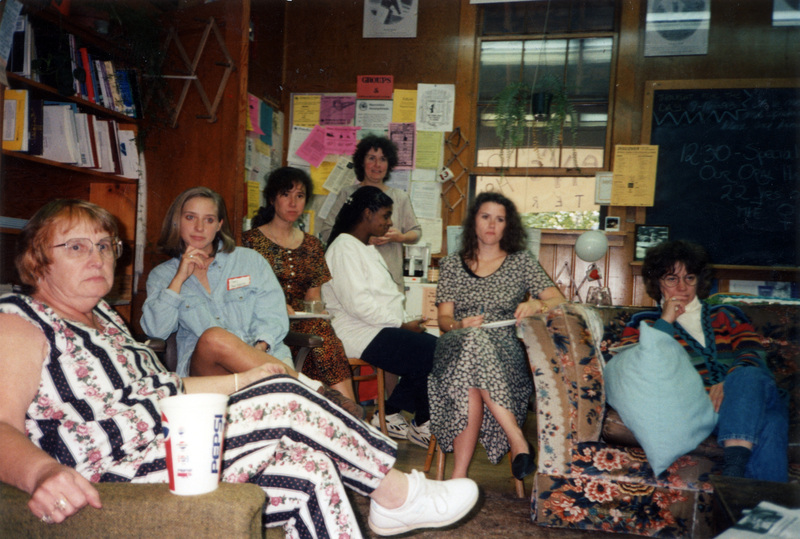 A group of women attending the Women's Center Open House. They appear to be looking at something behind the camera.