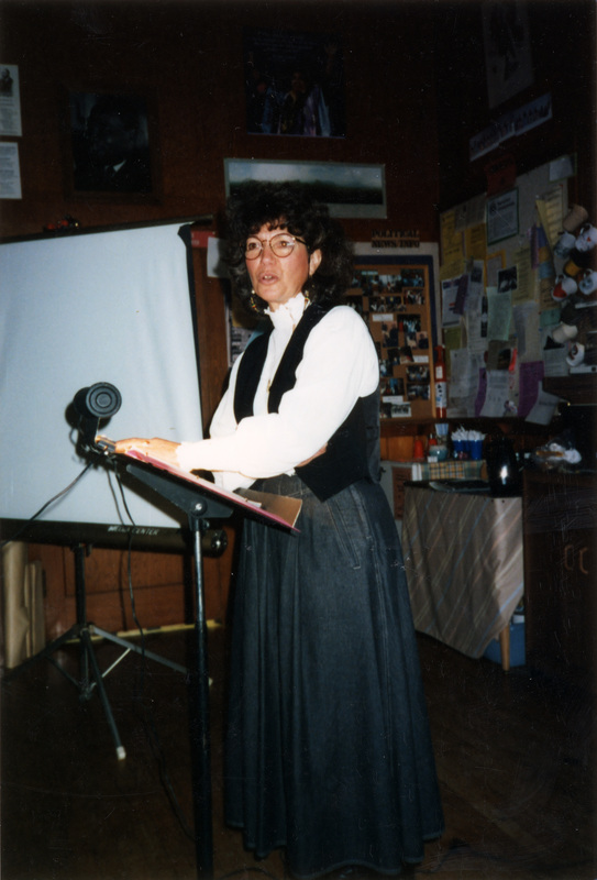 Lauren Fins, a University of Idaho natural resources professor, speaking in the Women's Center. She's using a music stand as a podium.
