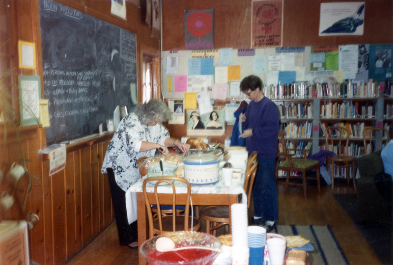 Two women at the 1992 Thanksgiving Potluck, serving food.