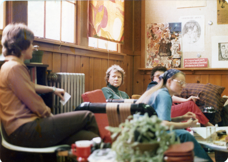 A group of people sitting on couches and chairs in the Women's Center.