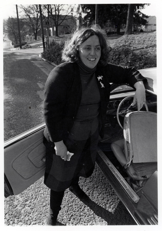 Linda Blackwelder Pall, former City Councilor, standing next to a car.