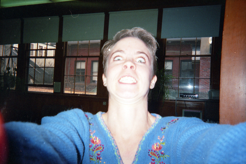Mary Lu Schweitzer making a face at the camera inside the Women's Center. Her arms are outstretched towards the camera, as if taking a selfie.