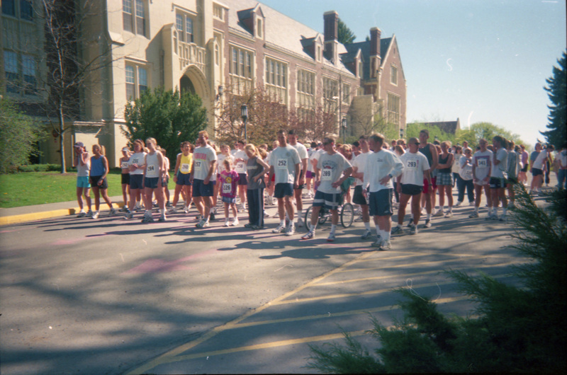 People wait for a race to start. The Administration Building can be seen in the background.