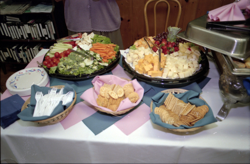A photo of a spread of food, including vegetables, crackers, and cheeses.