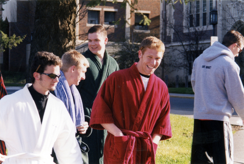 A group of men, most wearing bathrobes.