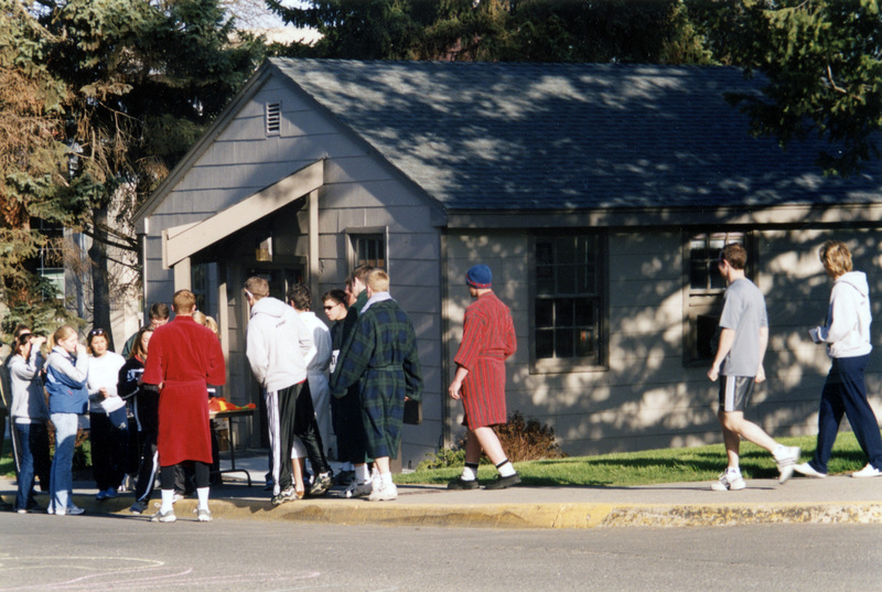 A group of people gathering outside a building.