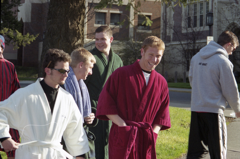 A group of men, most wearing bathrobes.