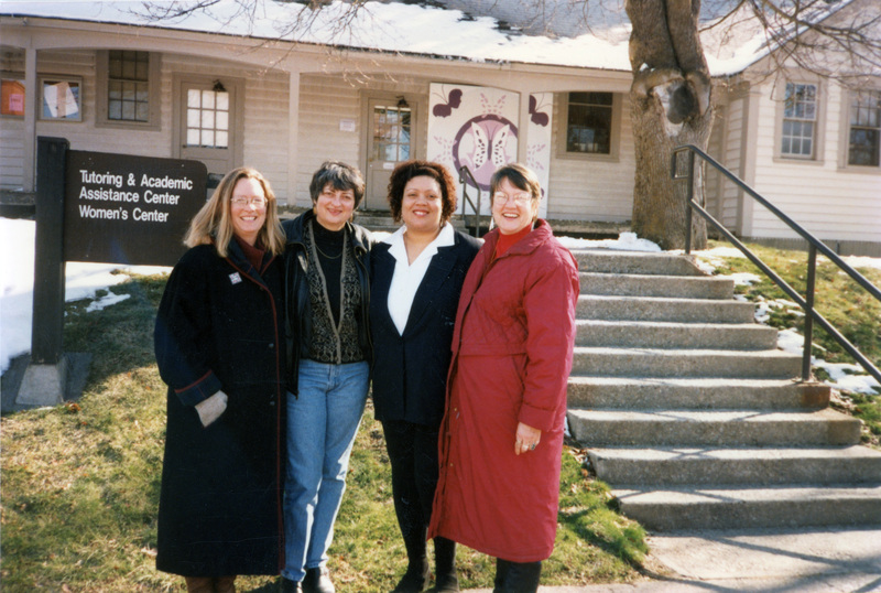 Four women standing outside the Tutoring and Academic Assistance Center and Women's Center. Susan Palmer (furthest left), Ann Neel (second to the left), and Betsy Thomas (furthest right) are in the photo.