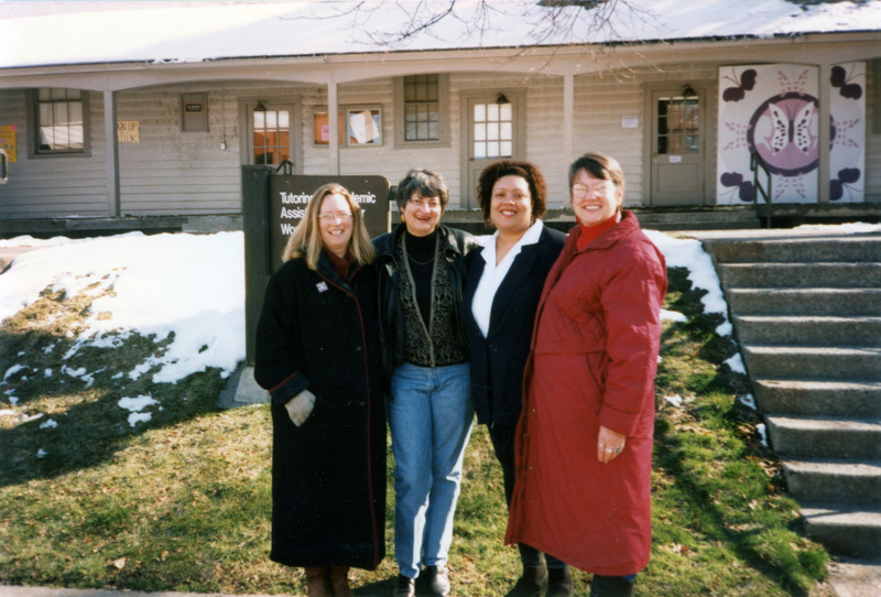 Entangled Lives: Facing our Slaveholding Past; February 28 and 29, 1996; two copies; Four women standing outside the Tutoring and Academic Assistance Center and Women's Center. Susan Palmer (furthest left), Ann Neel (second to the left), and Betsy Thomas (furthest right) are in the photo.