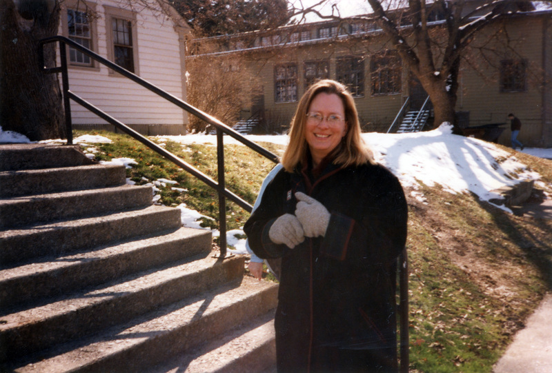 Susan Palmer standing outside the Tutoring and Academic Assistance Center and the Women's Center.