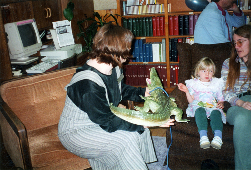 Right: Sheila O'Brien (English) and daughter Lillian Tarabulski sitting in the Women's Center. An unidentified woman sits on the left holding a toy crocodile.