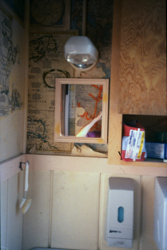 A photo of a mirror in Women's Center bathroom in the Old Journalism Building. Women's Center relocation from the Old Journalism Building to the Theatre Annex, Summer 2000.