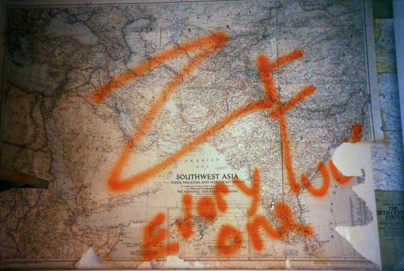 A photo of a map of southwest Asia. There is bright orange markings on the map. Women's Center relocation from the Old Journalism Building to the Theatre Annex, Summer 2000.