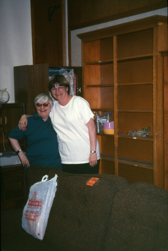 Jama Sebald and Jill Anderson hugging for the camera. Women's Center relocation from the Old Journalism Building to the Theatre Annex, Summer 2000.