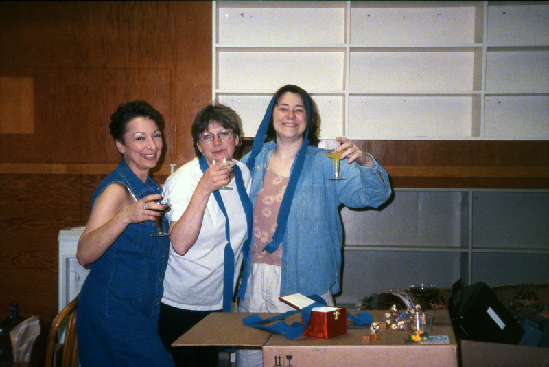 From left to right: Valerie Russo, Jill Anderson, and Chaucey Wittinger, raising champagne glasses. Women's Center relocation from the Old Journalism Building to the Theatre Annex, Summer 2000.