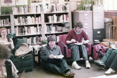 Three women eating inside the Women's Center