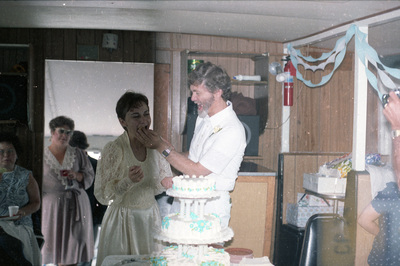 Groom feeds the bride a piece of wedding cake